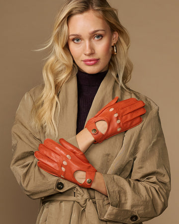 Women's orange lambskin driving gloves with touchscreen fingertips, snap wrist