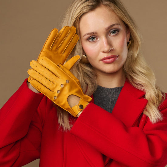 Yellow lambskin driving gloves with touchscreen fingertips and stitched holes