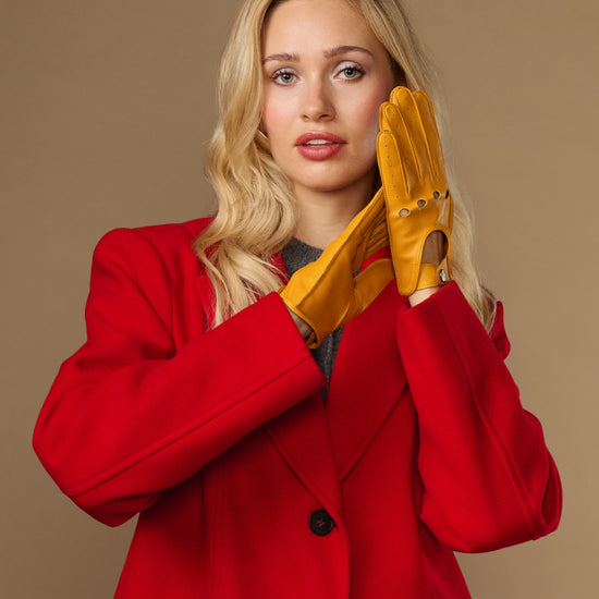 Yellow lambskin driving gloves with perforated seams and touchscreen fingertips