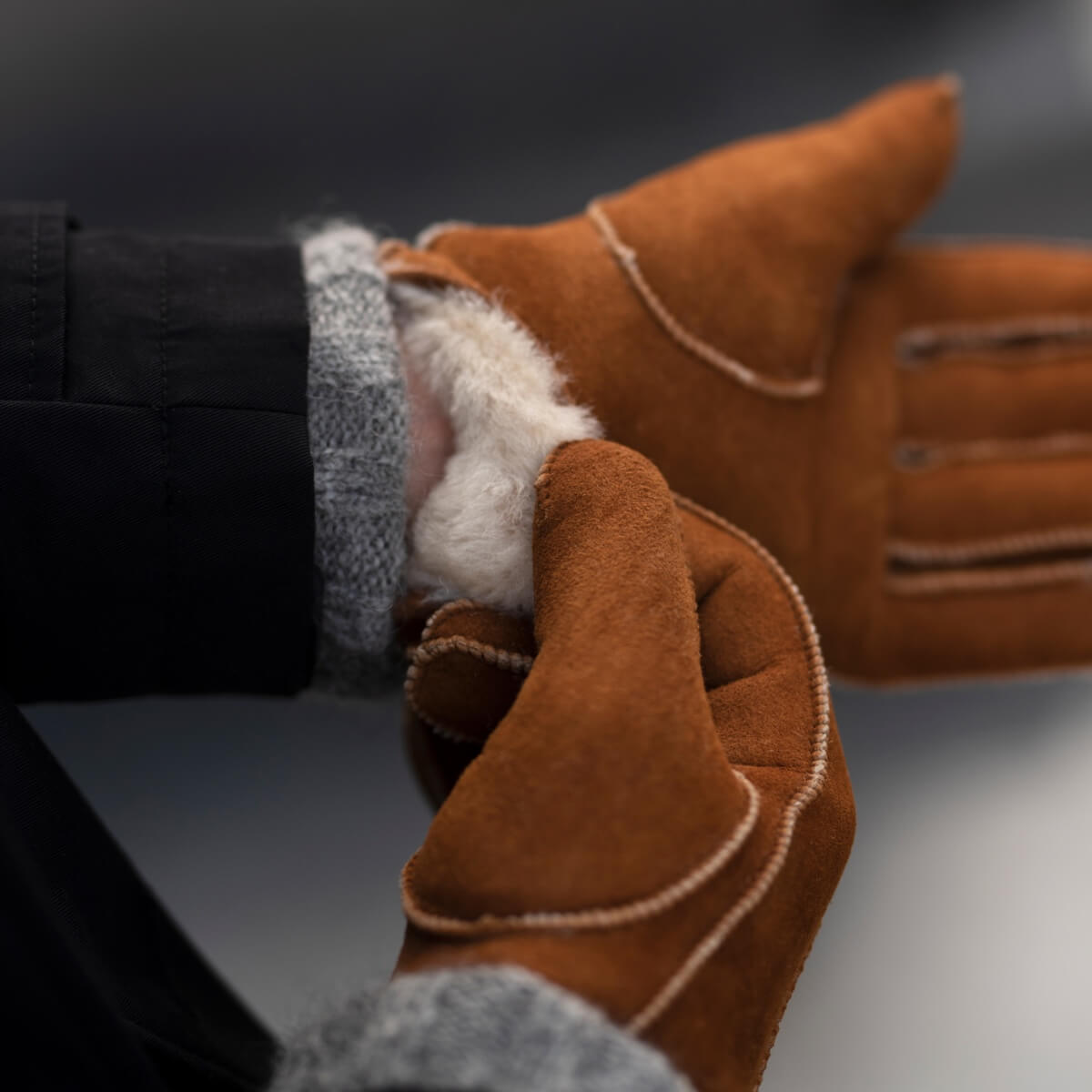 Camel suede glove cuff with exposed sheep fur lining and thumb patch