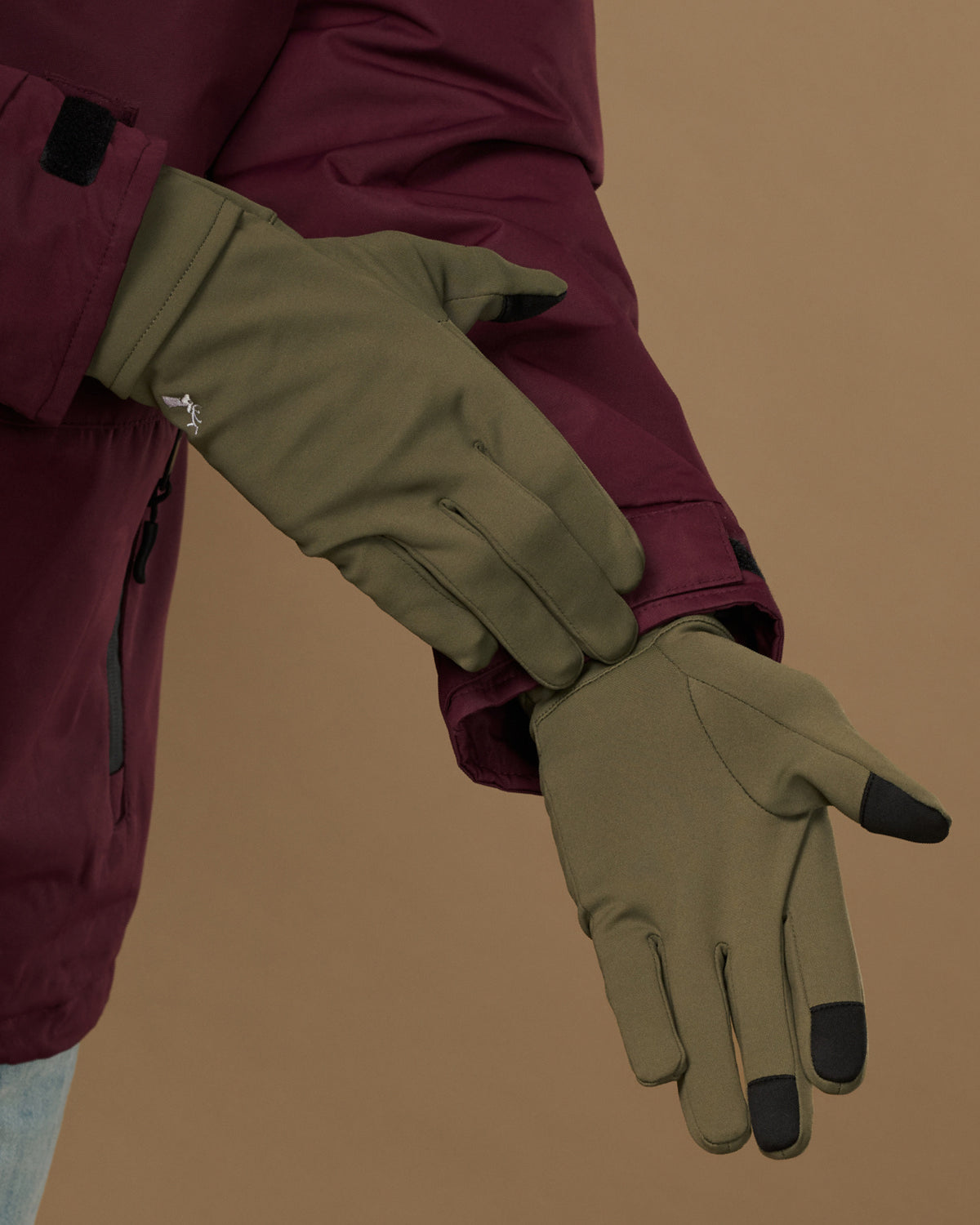 Olive green gloves with black touchscreen fingertips and wrist closures