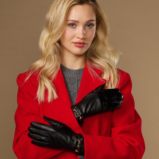 Black leather women's gloves with gold-tone buckle detail and touchscreen fingertips