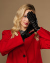 Black leather gloves worn with gold-tone buckle cuff
