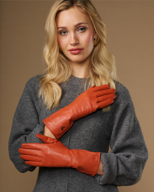 Orange leather gloves with long cuffs and stitched fingertips, cashmere-lined look