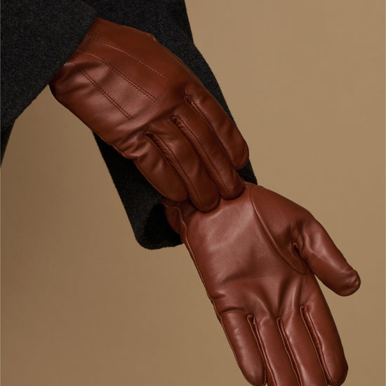 Cognac leather glove palm and fingers with stitched seams and fleece-lined cuff