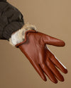 Women’s cognac leather gloves with white rabbit-fur cuff lining and finger seams