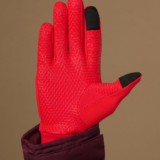 Red activity glove with textured grip palm and black touchscreen fingertips