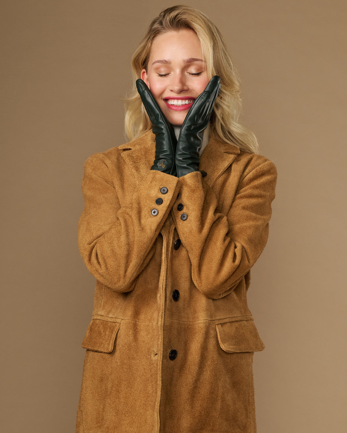 Dark green leather gloves with silk lining, finger seams, and touchscreen-compatible tips