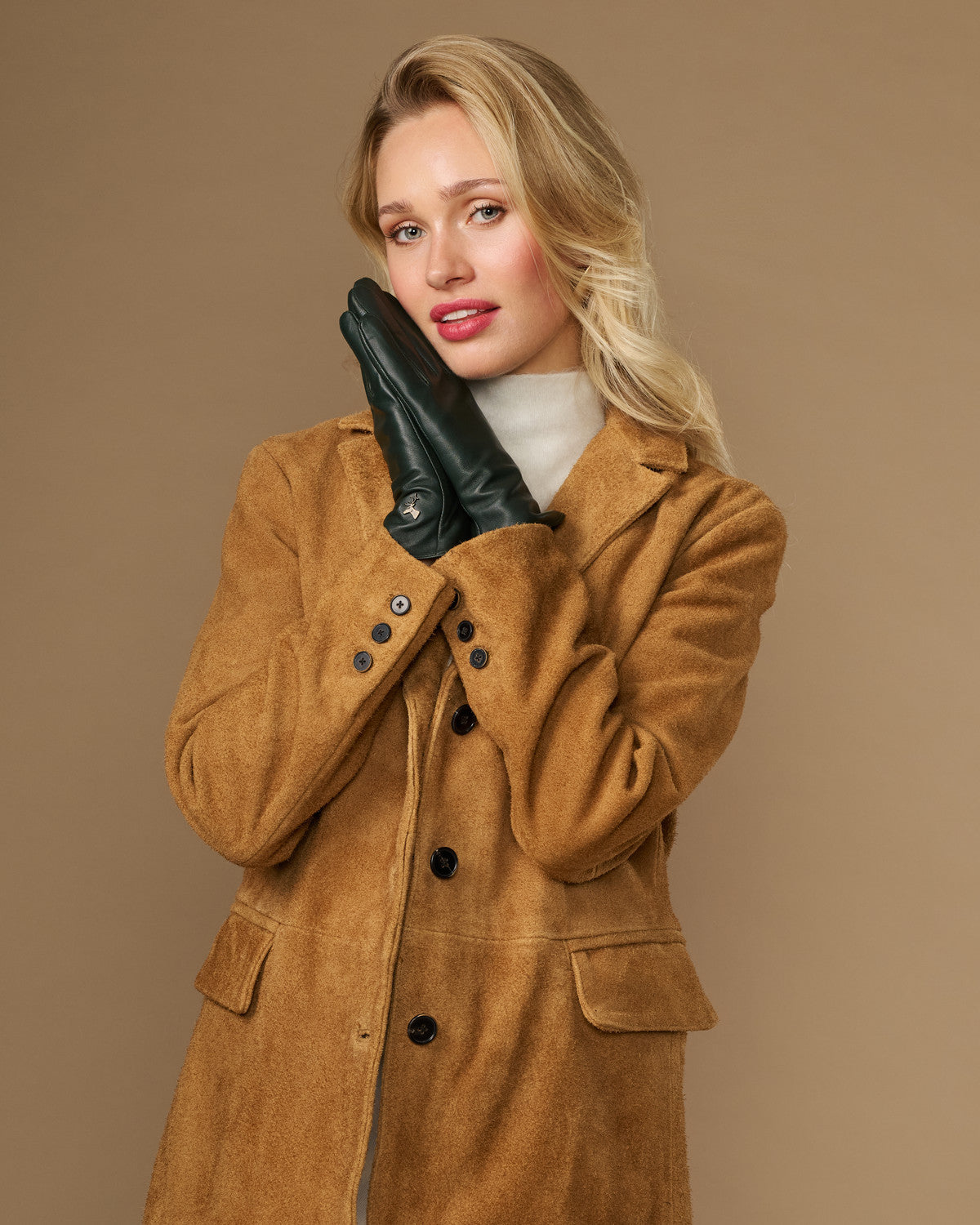 Dark green leather gloves with stitched detailing, snug cuffs, and touchscreen fingertips