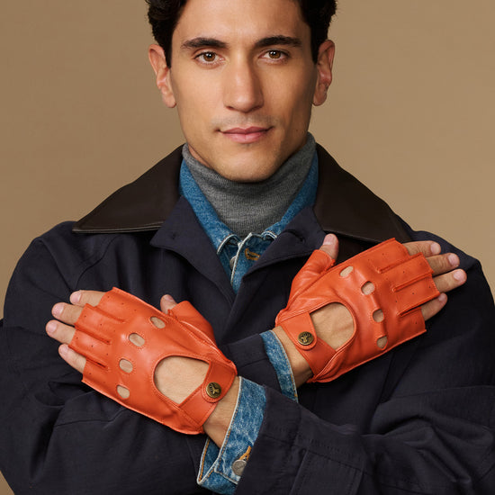 Men's orange fingerless lambskin driving gloves with stitched finger cutouts and cuff tabs