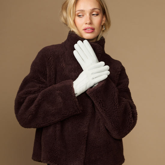 White sheepskin leather gloves with fleece lining, pair covering model's hands