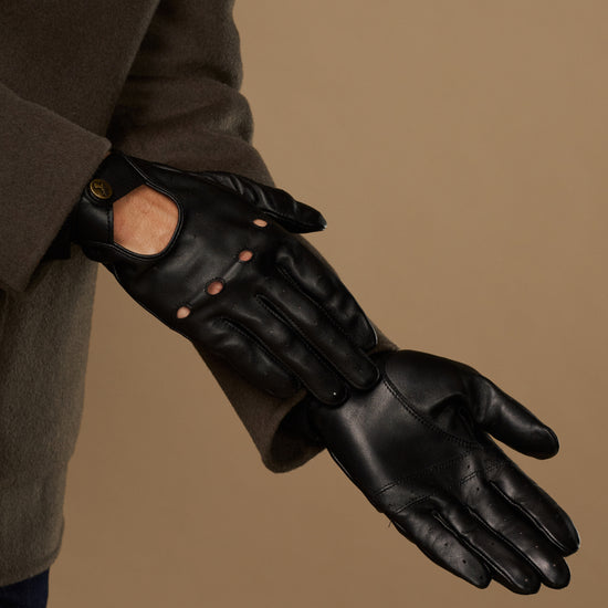 Black leather driving glove with touchscreen opening, worn with cuff and sleeve
