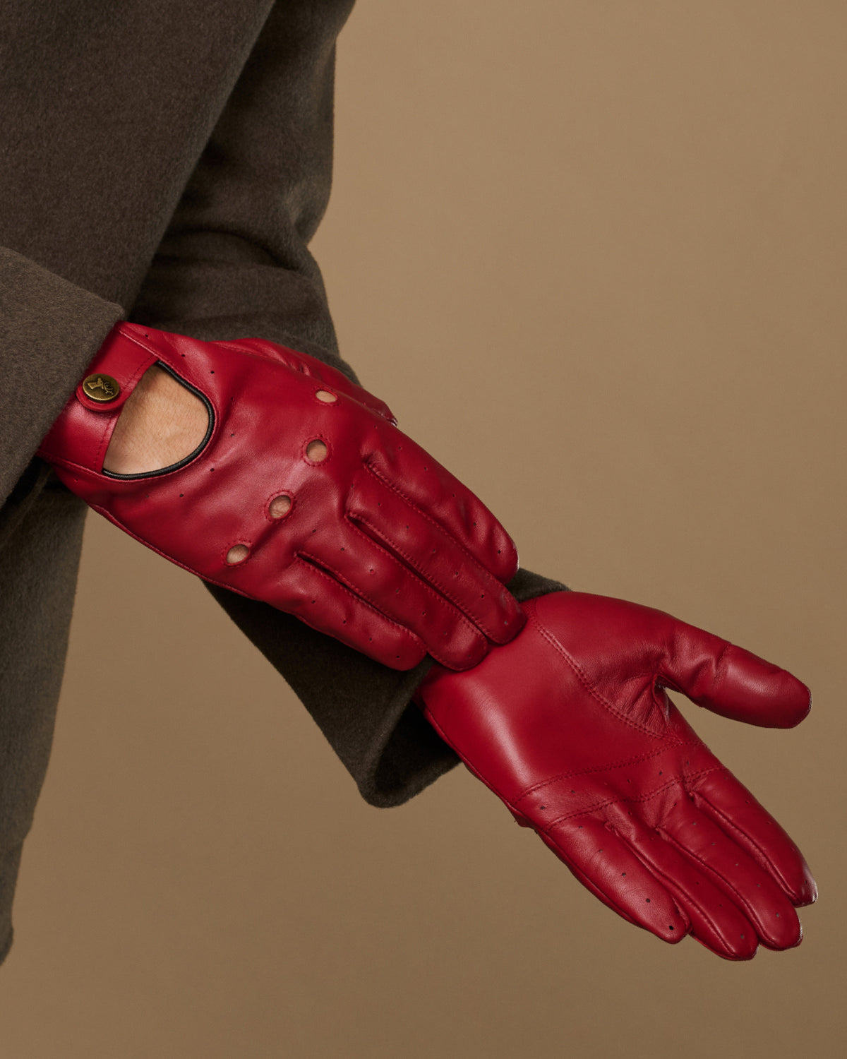 Men's red leather driving gloves, side view with open thumb and stitched knuckles