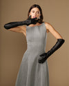Women’s black leather elbow gloves with touchscreen use while holding a phone