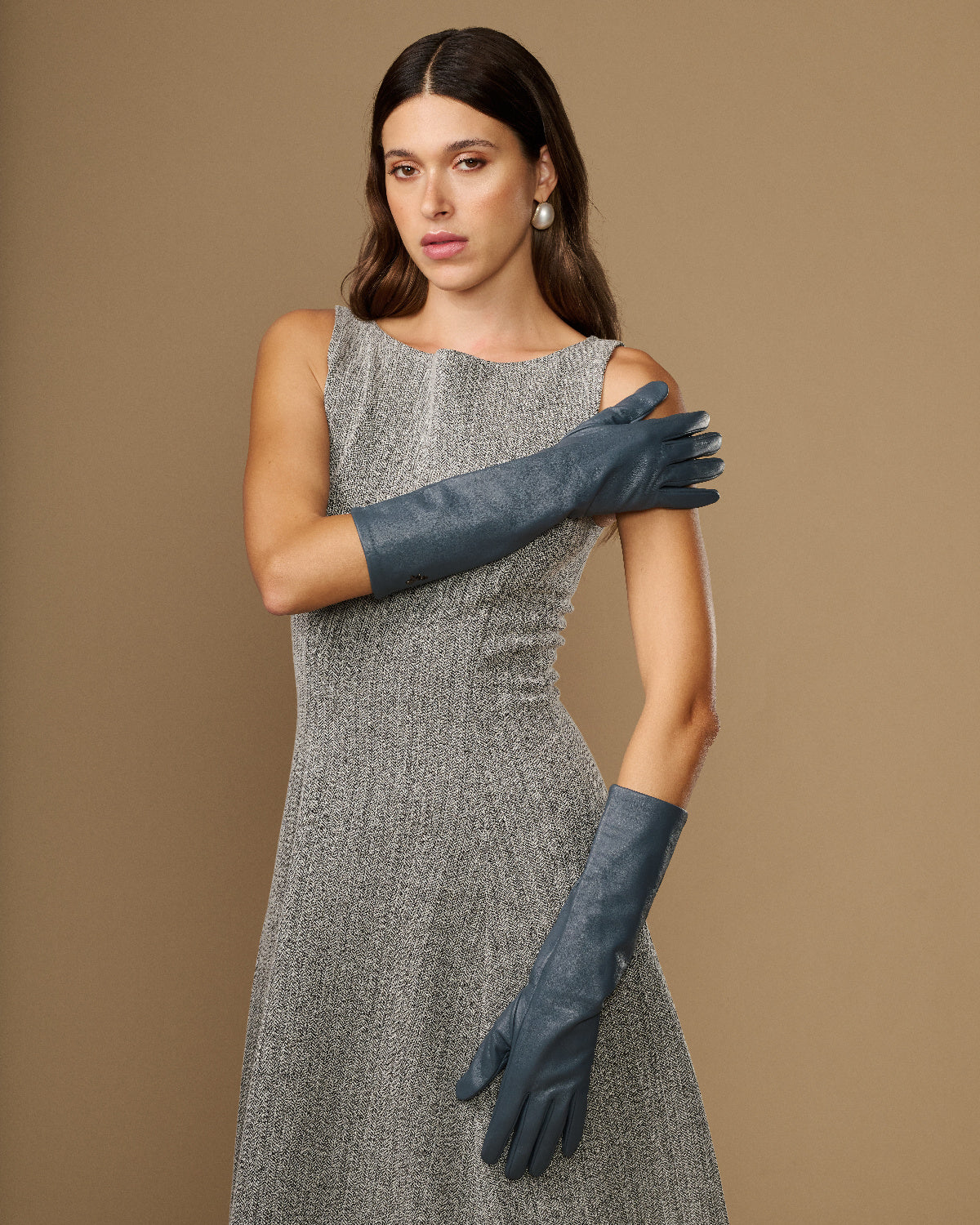 Women’s grey below-elbow leather gloves with long cuffs and curved finger shaping