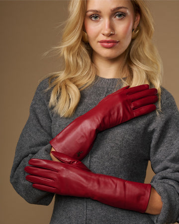 Red lambskin leather mid-forearm gloves with smooth cuffs and stitched fingers