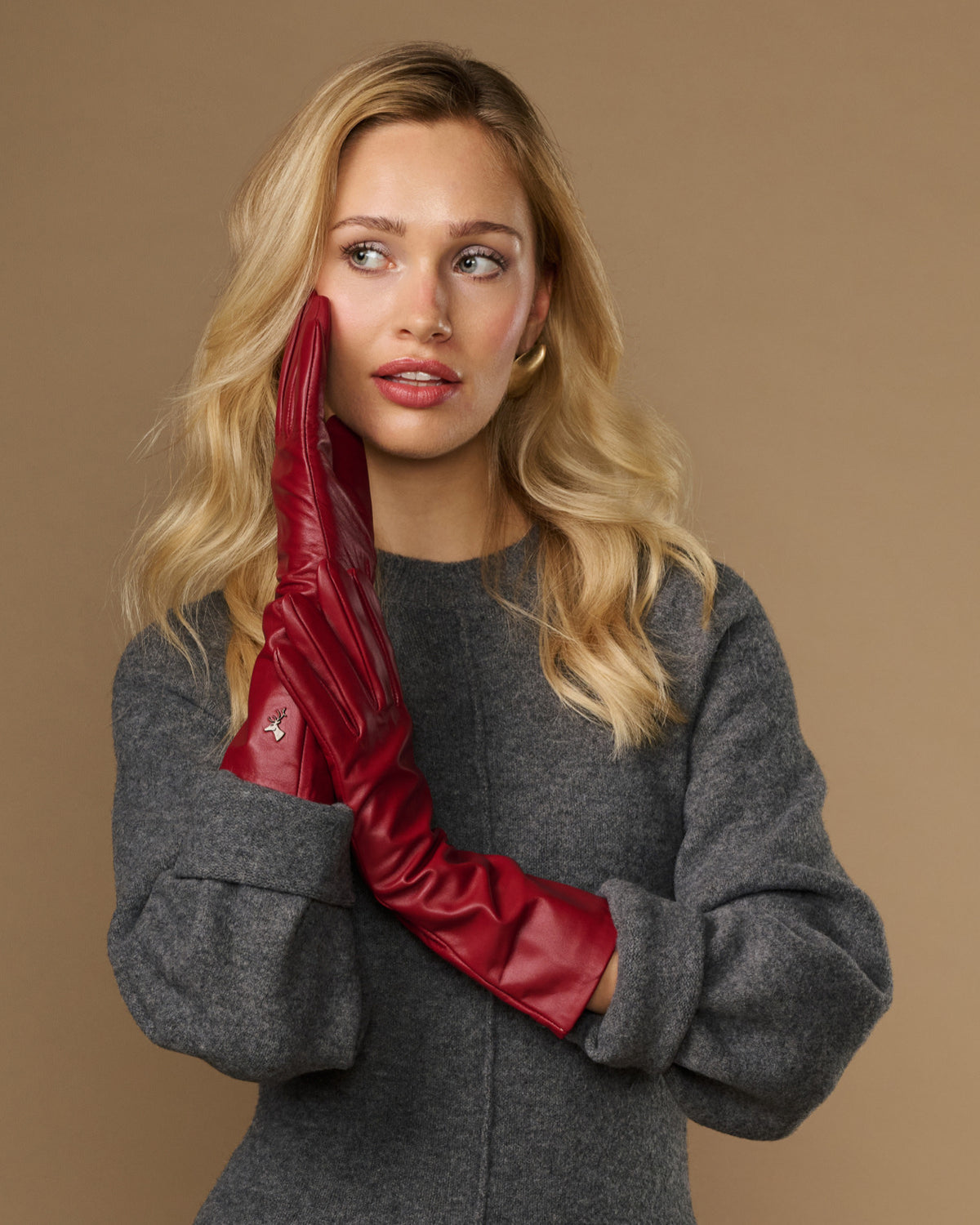 Red leather mid-forearm gloves with tailored seams and smooth wrist opening