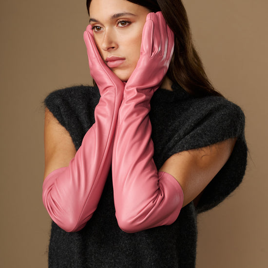 Women's pink leather gloves with long cuffs, draped in front