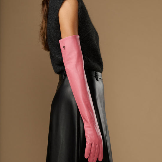 Women's pink leather gloves with long cuff, side view on arm