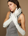 White elbow-length leather gloves with smooth palms and curved finger panels