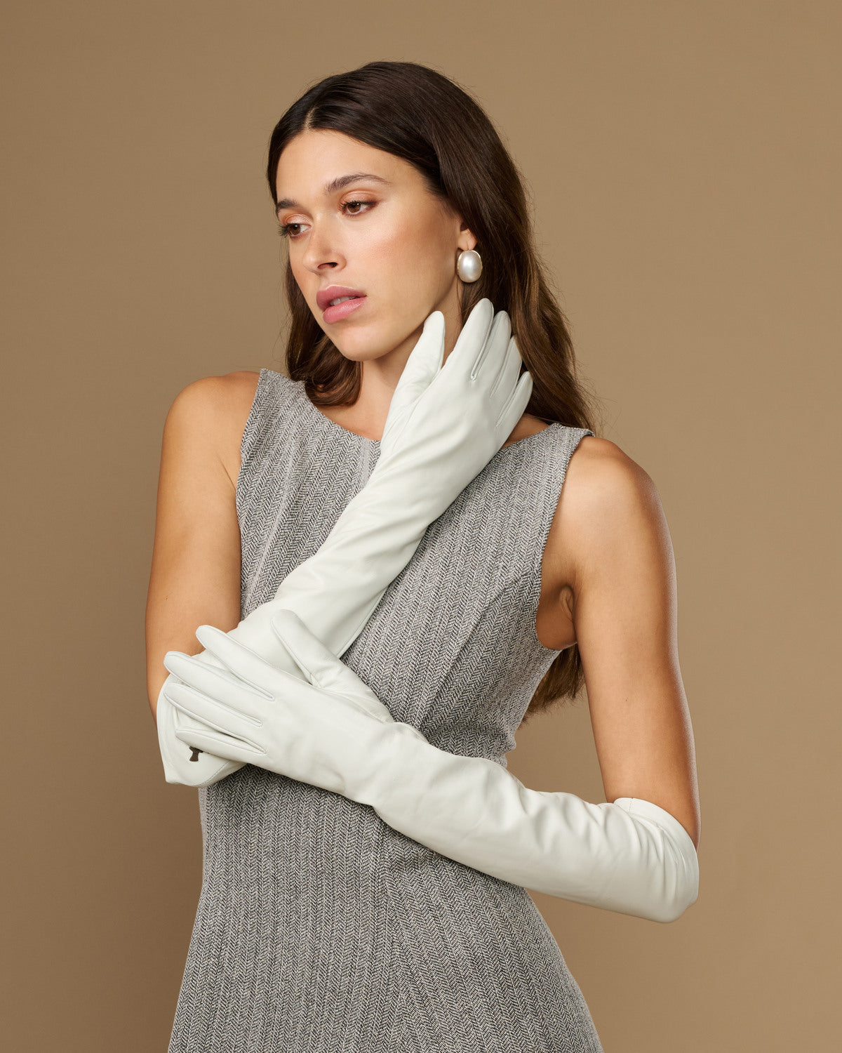White elbow-length leather gloves with clean stitching lines and snug wrist cuff