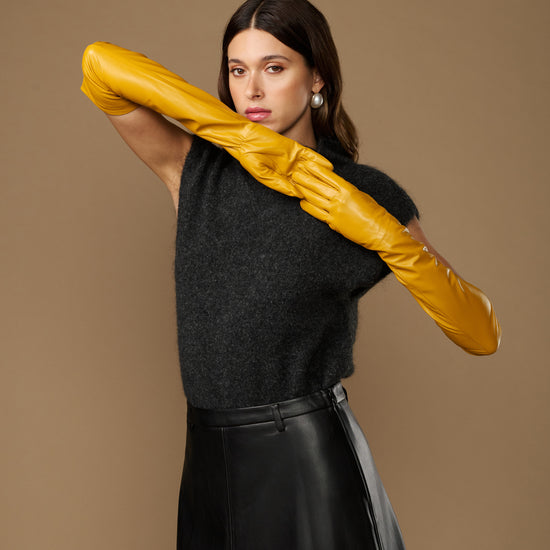 Yellow lambskin leather opera gloves, long fitted style held overhead