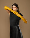 Yellow lambskin leather opera gloves, long fitted style held overhead