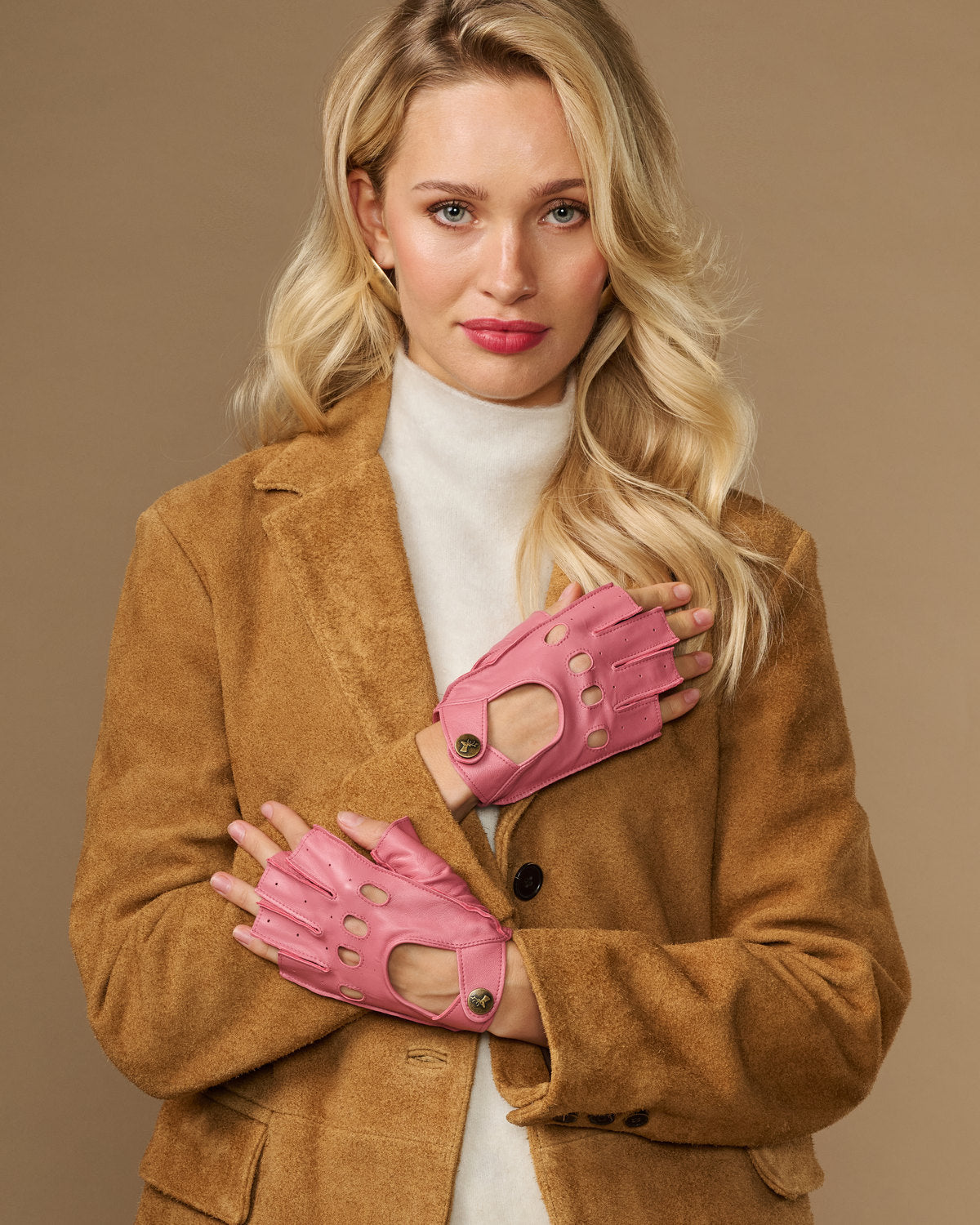 Pink fingerless lambskin driving gloves, worn with open finger tops and snaps