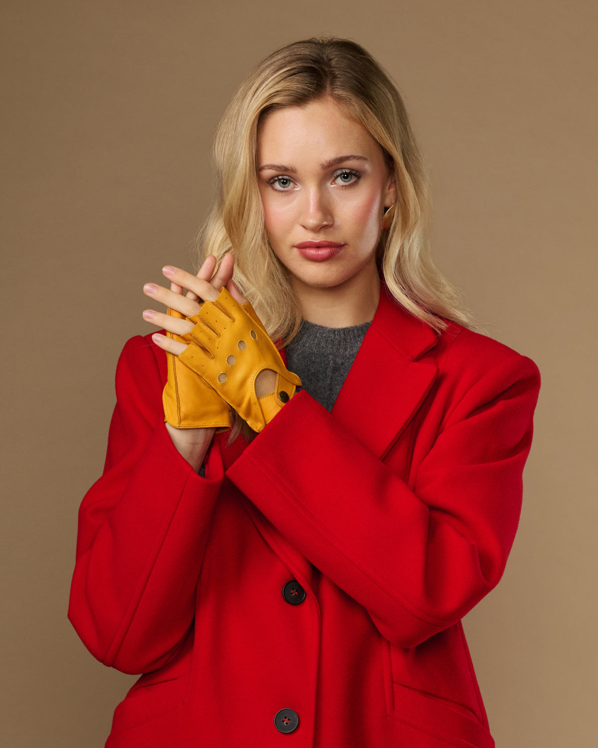 Yellow women's fingerless lambskin gloves with perforated knuckles and snap cuff