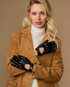 Black leather driving gloves with decorative snaps and elastic wrist opening.