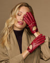 Women’s red leather driving gloves with elastic wrist and decorative studs