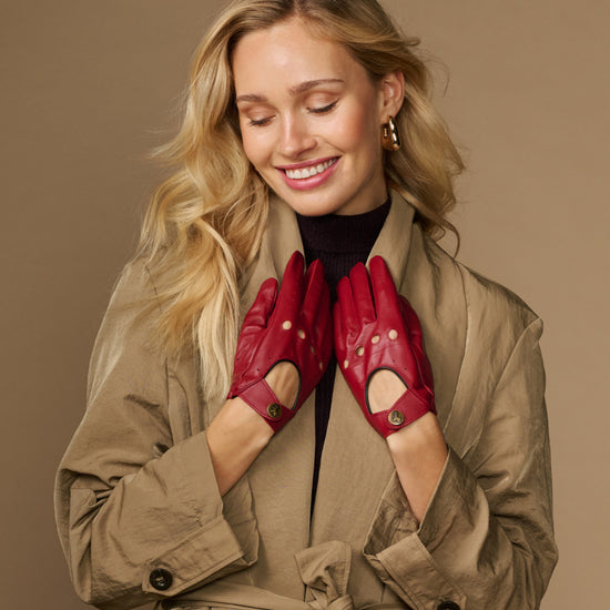 Women’s red leather driving gloves with perforations and button-detail cuff